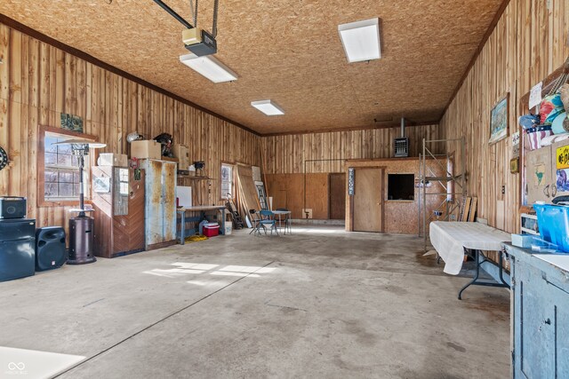 garage featuring wood walls and a garage door opener