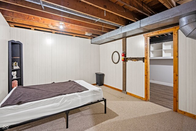 bedroom featuring baseboards and carpet