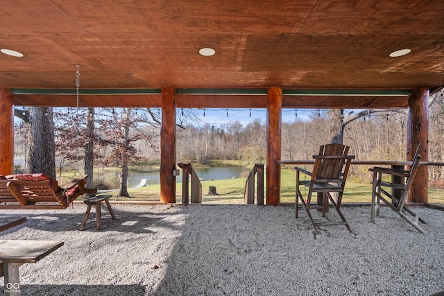 exterior space featuring wood ceiling and a water view