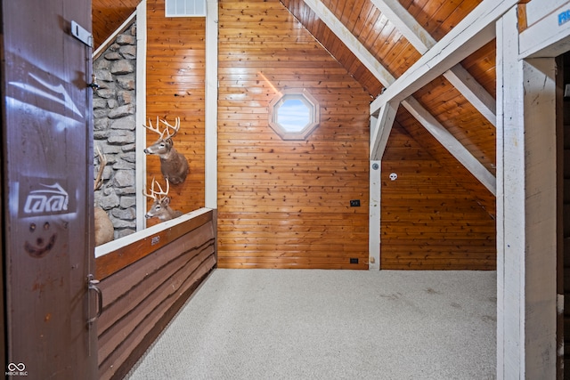 additional living space with wooden walls, wooden ceiling, and vaulted ceiling with beams