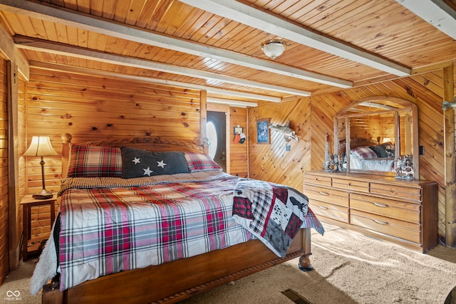 carpeted bedroom featuring beamed ceiling, wooden walls, and wood ceiling