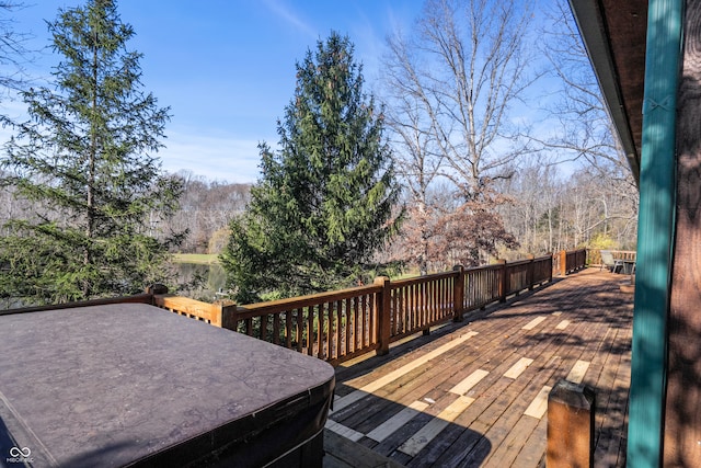 wooden deck with a hot tub