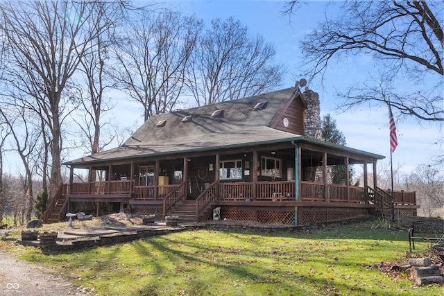 farmhouse inspired home featuring a shingled roof, a front lawn, stairway, a porch, and a chimney