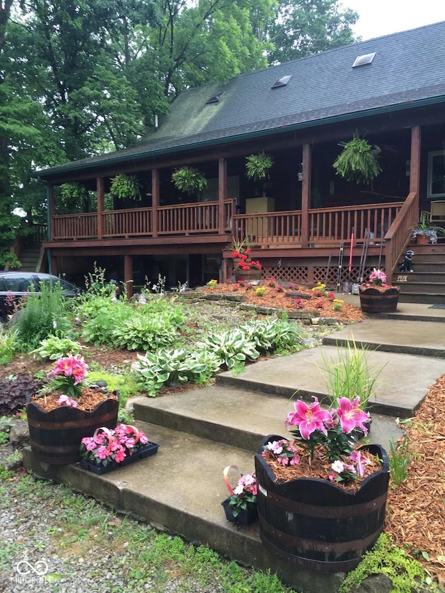 exterior space with roof with shingles