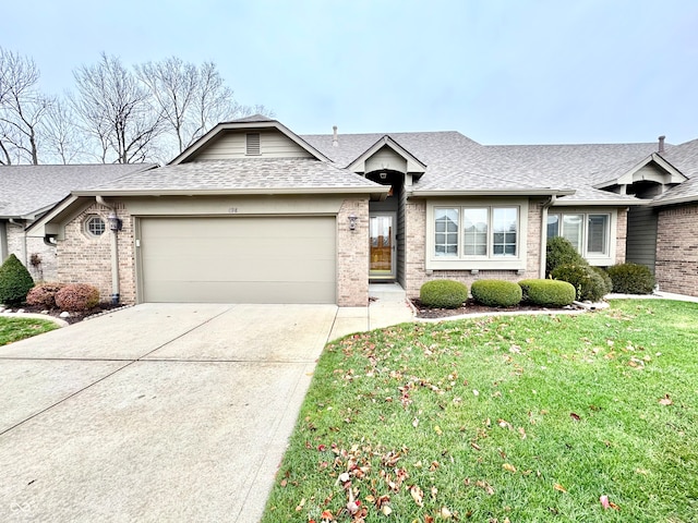 ranch-style home featuring a garage and a front lawn