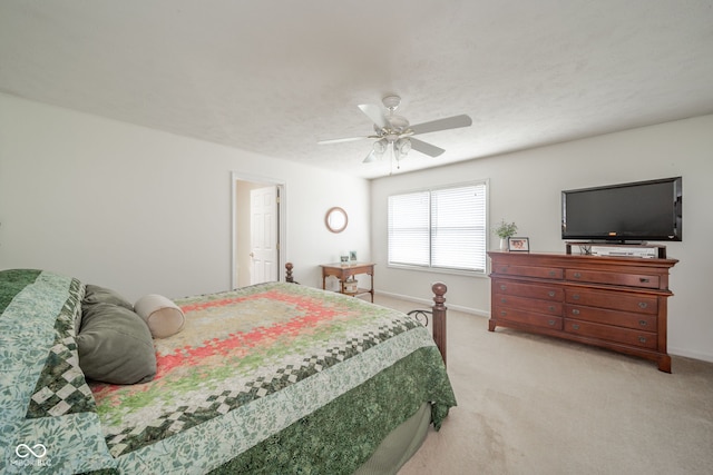 bedroom featuring ceiling fan and light carpet