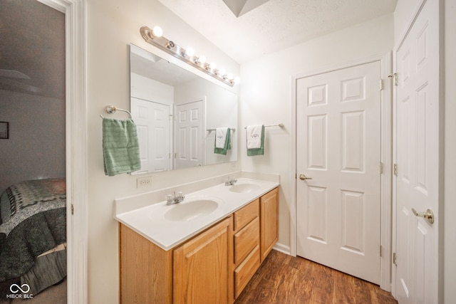 bathroom featuring vanity, a textured ceiling, and hardwood / wood-style flooring