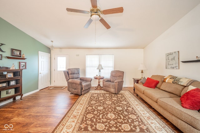 living room with hardwood / wood-style flooring, ceiling fan, and vaulted ceiling