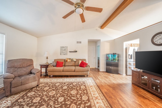 living room with ceiling fan, light hardwood / wood-style flooring, and lofted ceiling with beams