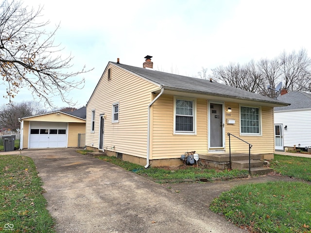 view of front facade featuring an outdoor structure and a garage