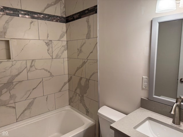 full bathroom featuring vanity, toilet, and tiled shower / bath