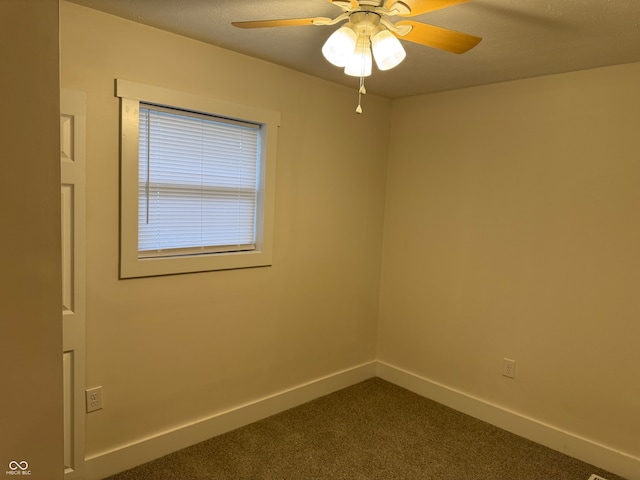 carpeted spare room featuring ceiling fan