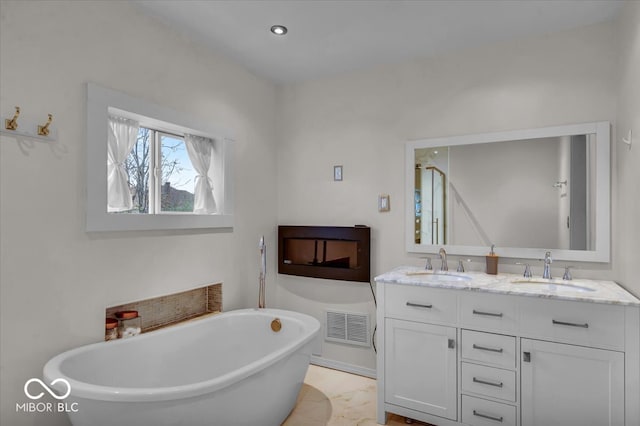 bathroom featuring vanity and a bath