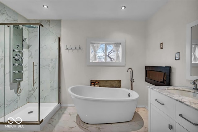 bathroom featuring shower with separate bathtub and vanity