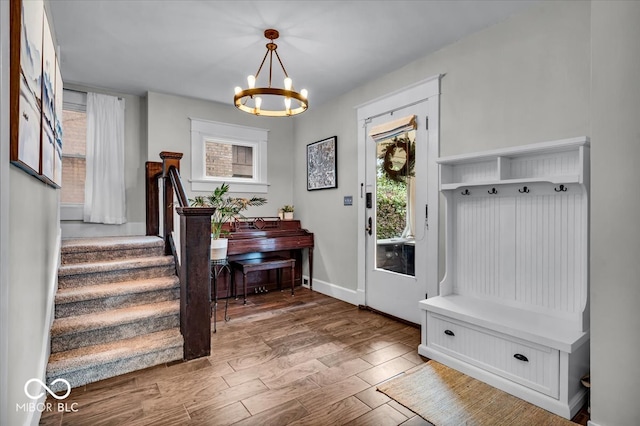 mudroom featuring wood-type flooring and a chandelier