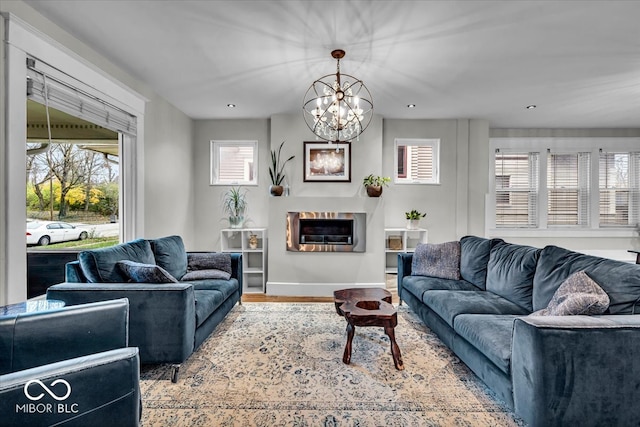 living room with wood-type flooring and an inviting chandelier