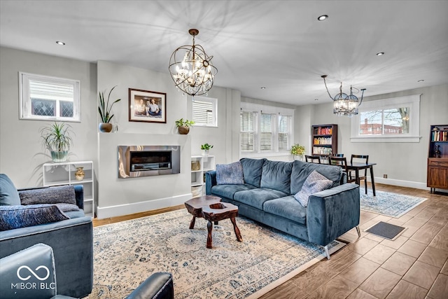 living room with a chandelier and wood-type flooring