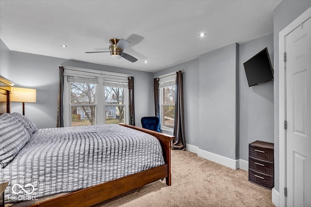 bedroom featuring ceiling fan and light carpet