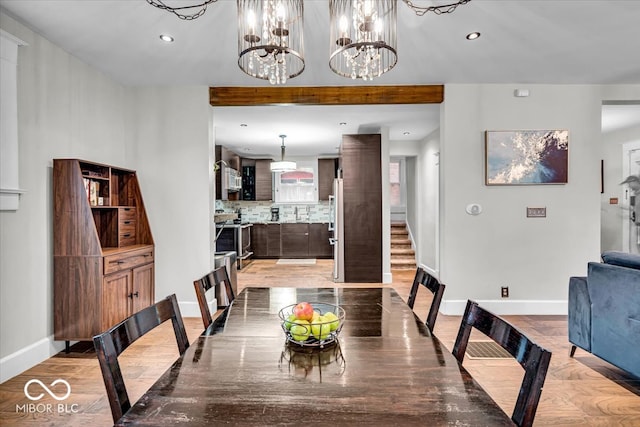 dining room featuring light hardwood / wood-style flooring and a chandelier