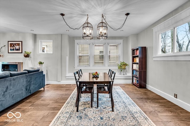 dining space with hardwood / wood-style flooring and a notable chandelier