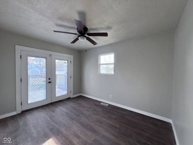 spare room featuring dark wood-style floors, french doors, baseboards, and ceiling fan