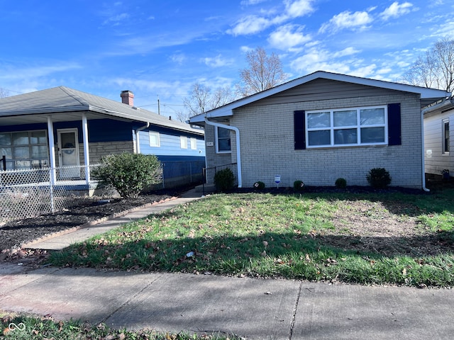 view of front facade featuring brick siding and a front lawn