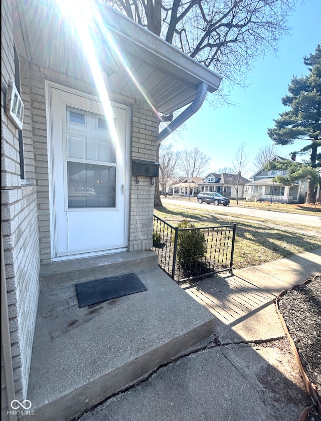 doorway to property with brick siding