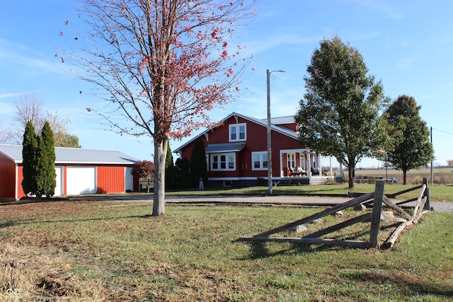 view of front of property with a front yard, an outbuilding, and a garage