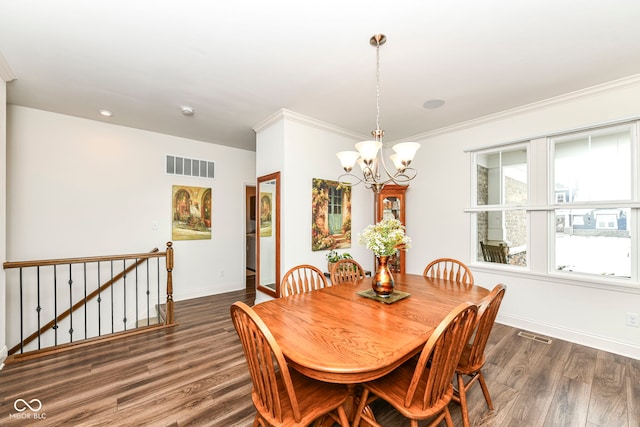 dining room with dark wood-type flooring, a notable chandelier, and crown molding