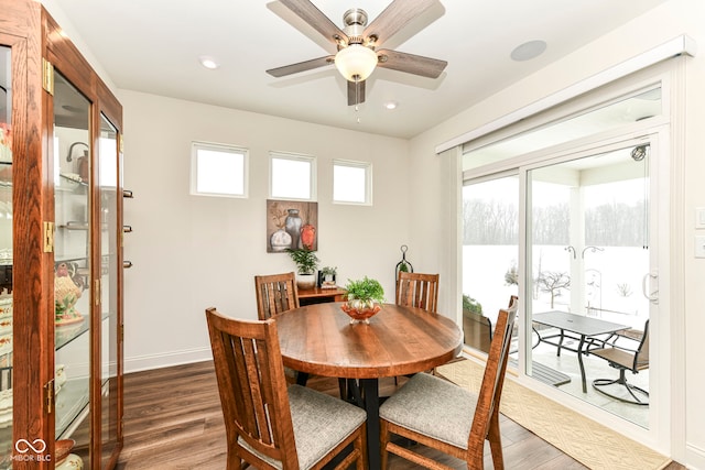 dining space featuring ceiling fan and dark wood-type flooring