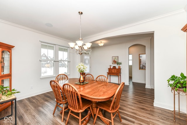 dining space featuring ornamental molding, dark wood-type flooring, and a chandelier