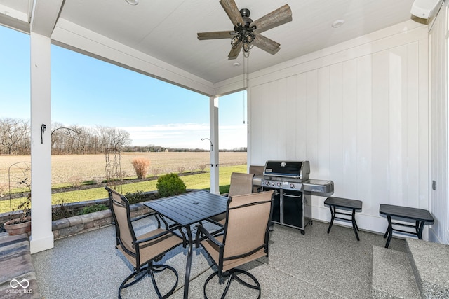 view of patio / terrace with grilling area, ceiling fan, and a rural view