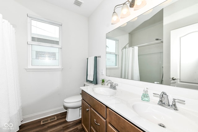 bathroom with toilet, wood-type flooring, and vanity