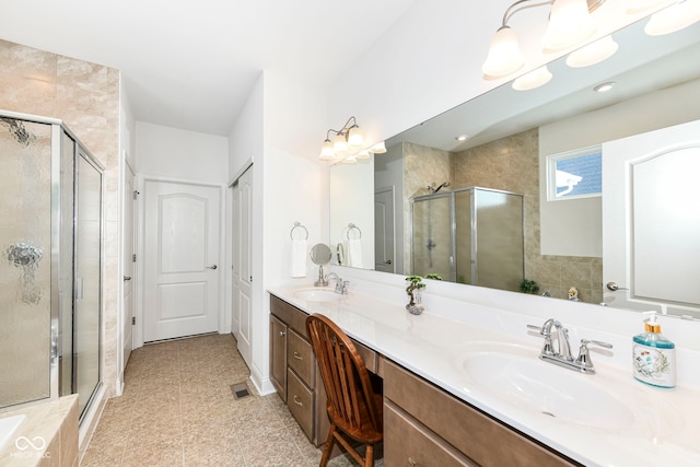 bathroom featuring an enclosed shower, vanity, and tile patterned flooring