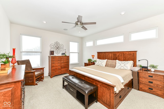 bedroom with multiple windows, light carpet, and ceiling fan