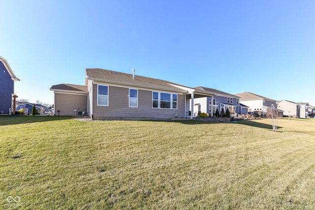 rear view of property featuring a yard