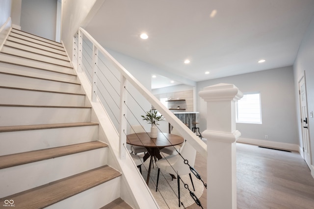 stairs featuring hardwood / wood-style floors