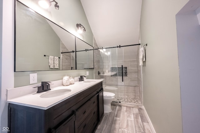 bathroom featuring hardwood / wood-style floors, an enclosed shower, vaulted ceiling, toilet, and vanity