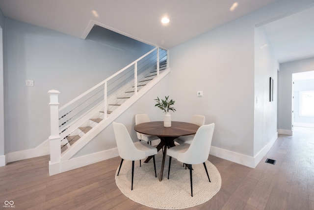 dining space with wood-type flooring