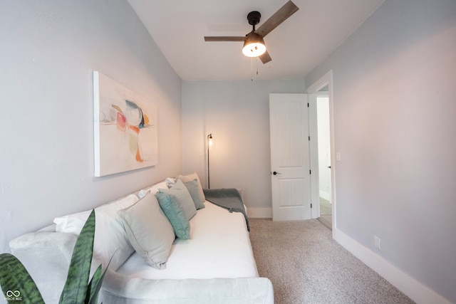 carpeted living room featuring ceiling fan