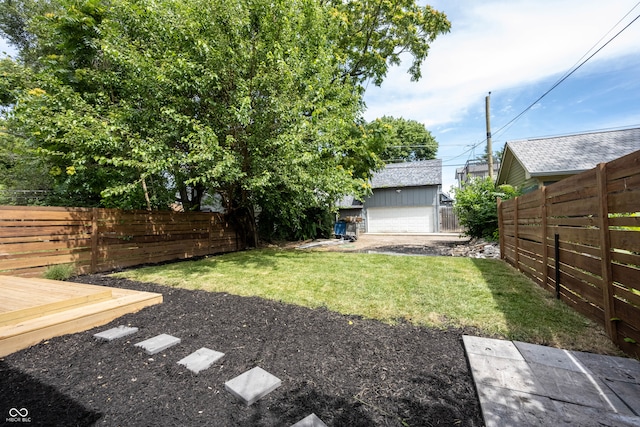 view of yard featuring an outbuilding and a garage