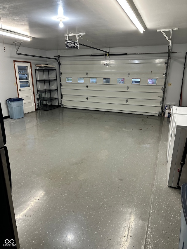 garage with washer / clothes dryer and a garage door opener