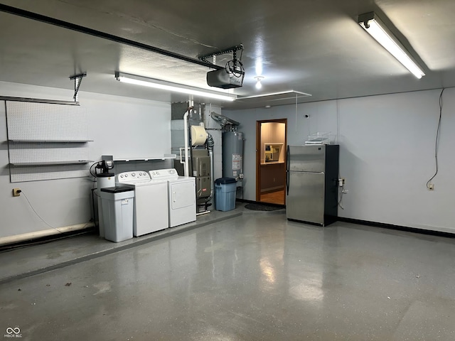 garage featuring stainless steel fridge, a garage door opener, washer and clothes dryer, and water heater