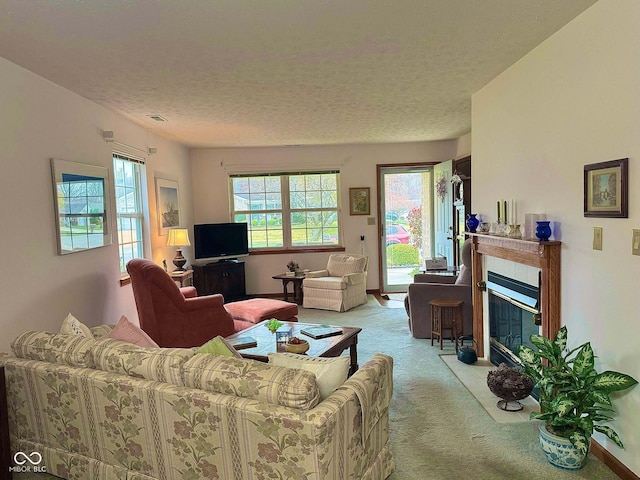 carpeted living room with a textured ceiling and a tiled fireplace