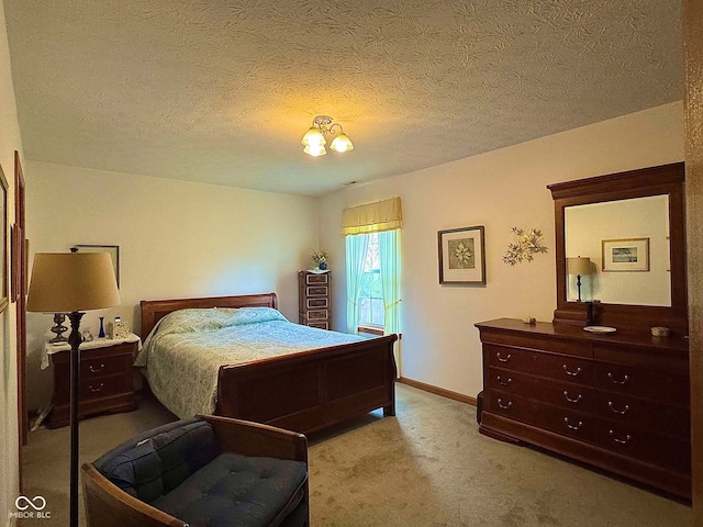 bedroom with a textured ceiling and light carpet