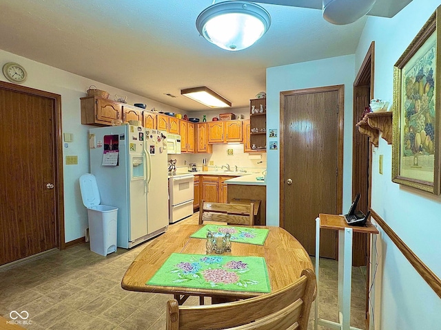 kitchen with white appliances and sink