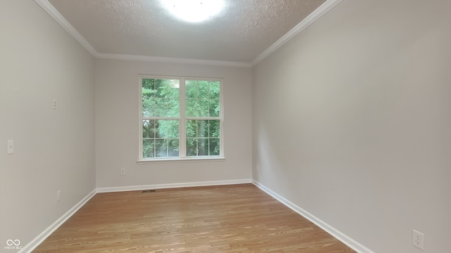 unfurnished room with a textured ceiling, light hardwood / wood-style floors, and ornamental molding