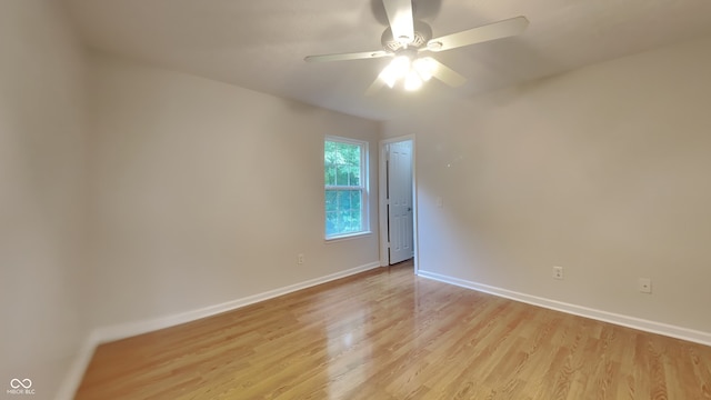 spare room featuring light hardwood / wood-style flooring and ceiling fan