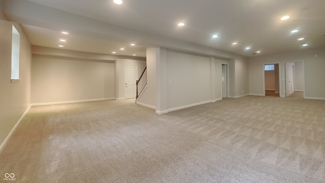 basement featuring light colored carpet