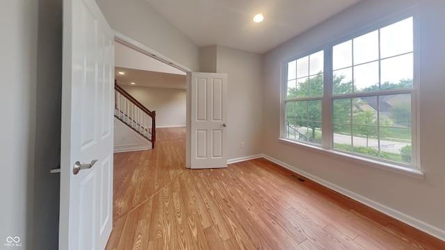 spare room featuring light wood-type flooring and a wealth of natural light